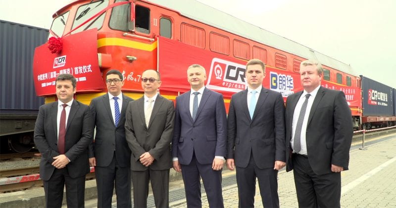 DHL and China rai officials standing in front of a Chinese freight train