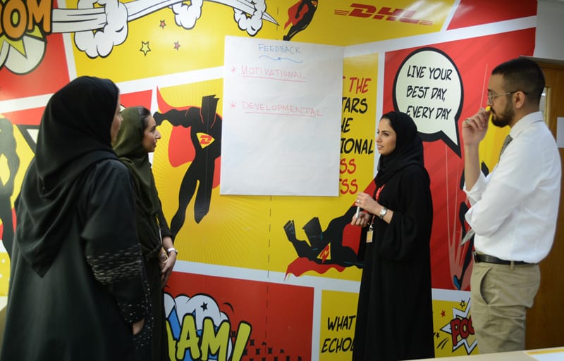 Al Sadlan engages her team members in a discussion