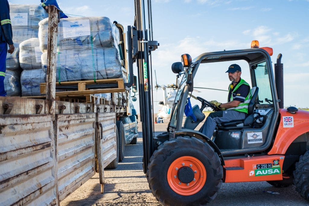 Mark Mitchell, a DRT volunteer, operates a forklift to load goods quickly onto a truck.