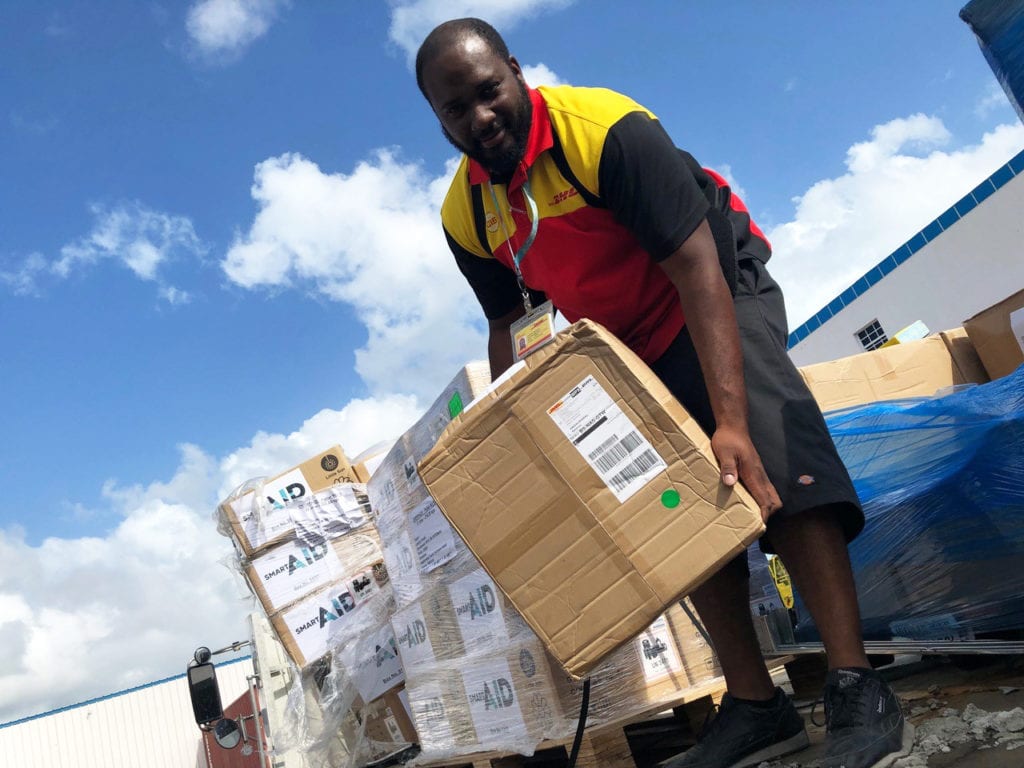 A DRT volunteer unloading aid relief goods