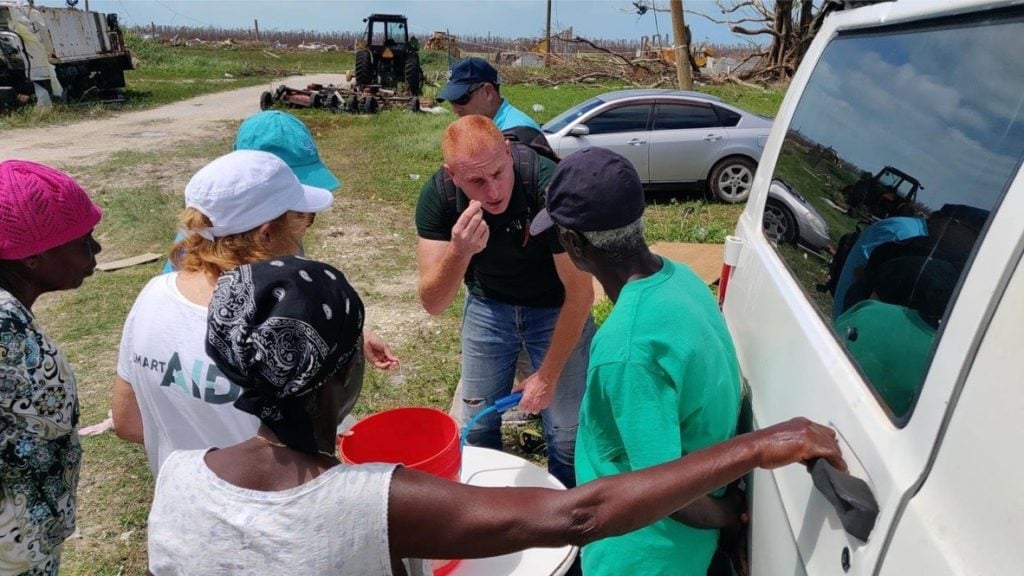 The smartAID team on Abaco Island teaching people how to work the water purifier from China