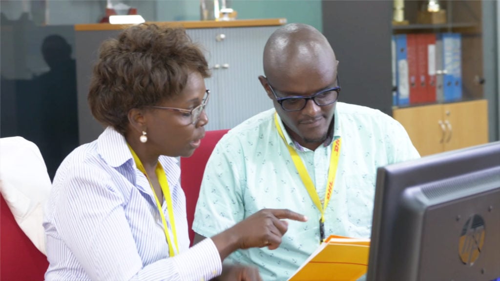 Agnes Kilei (left) guiding Moses Kiara at work