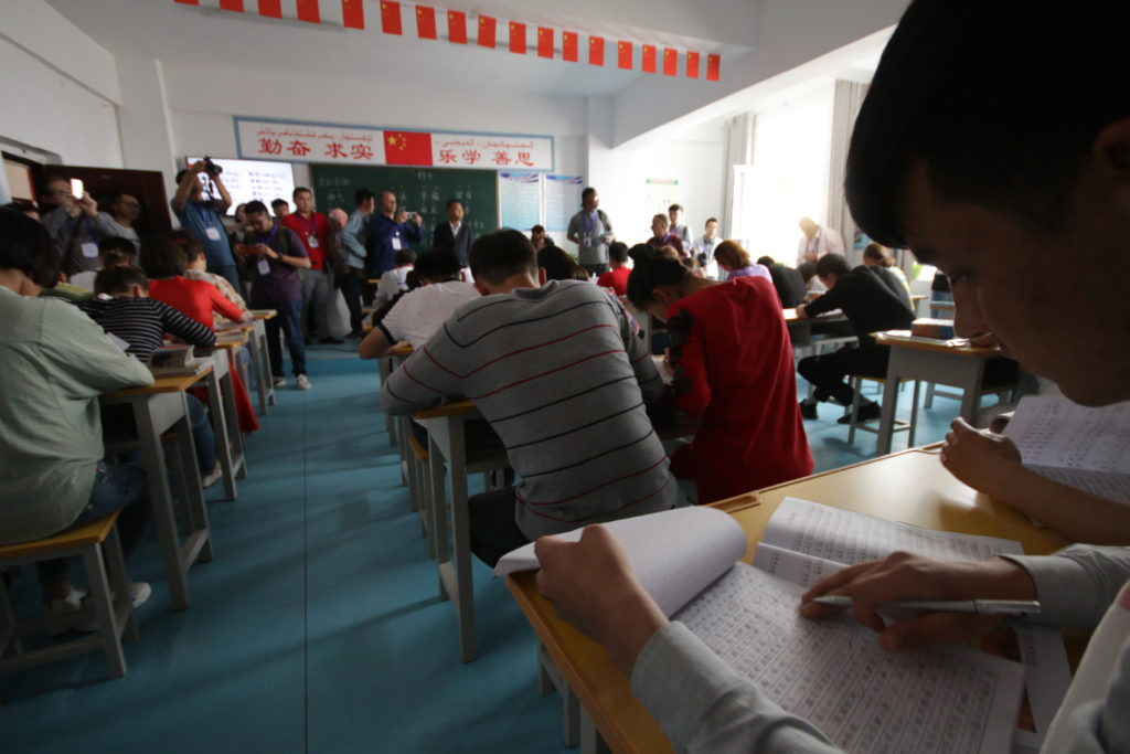 Uyghurs learn Chinese language at a re-education camp in Xinjiang, China.