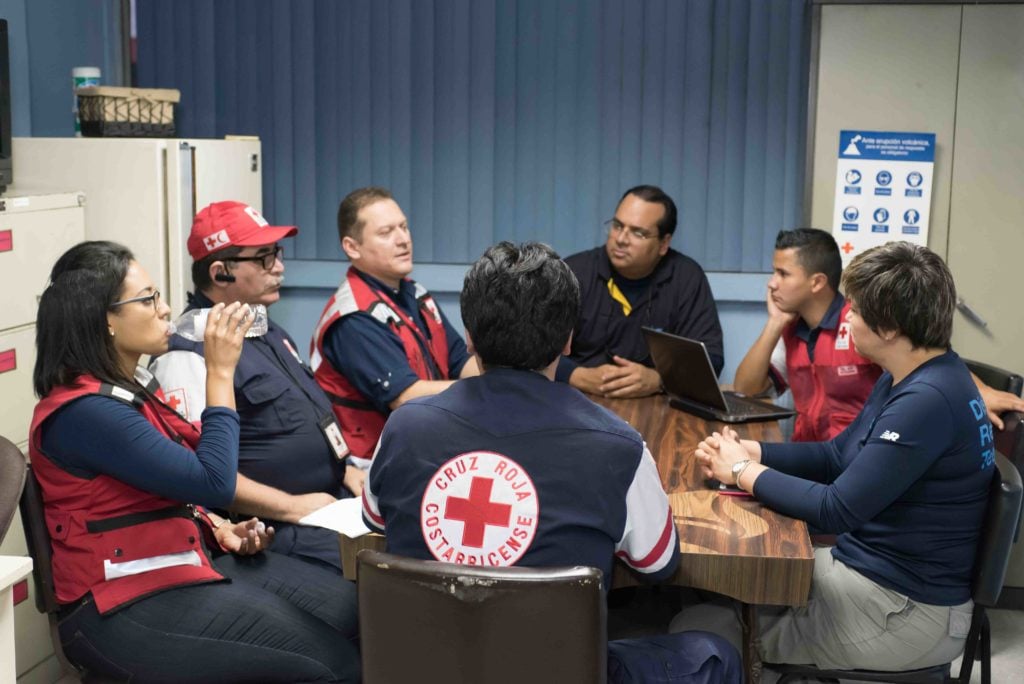 DHL volunteers in a meeting for disaster aid coordination.