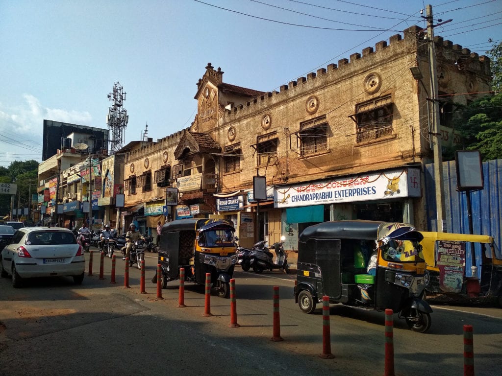 An old traditional building on a busy road in Hubli, Karnataka, India