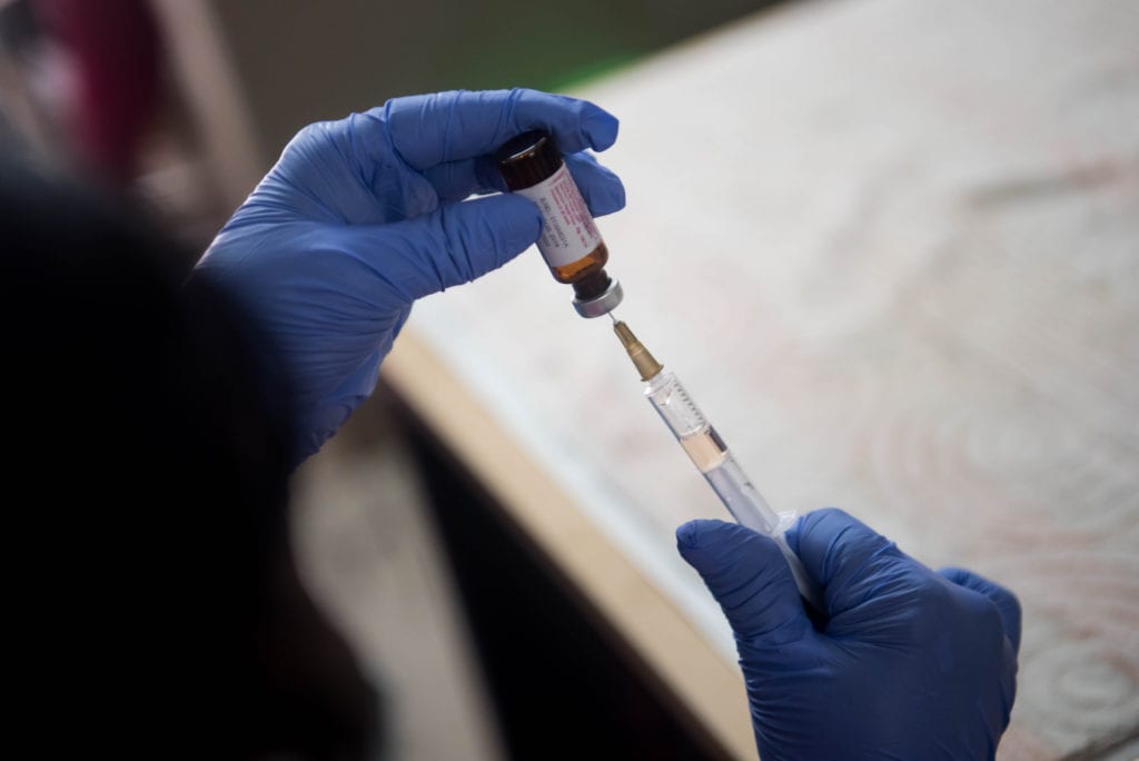 A medical worker preparing a vaccine