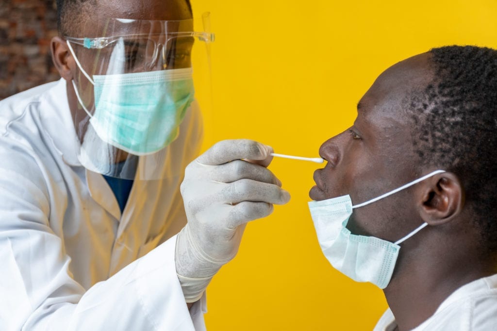 A medical personnel performing a Covid-19 swab test