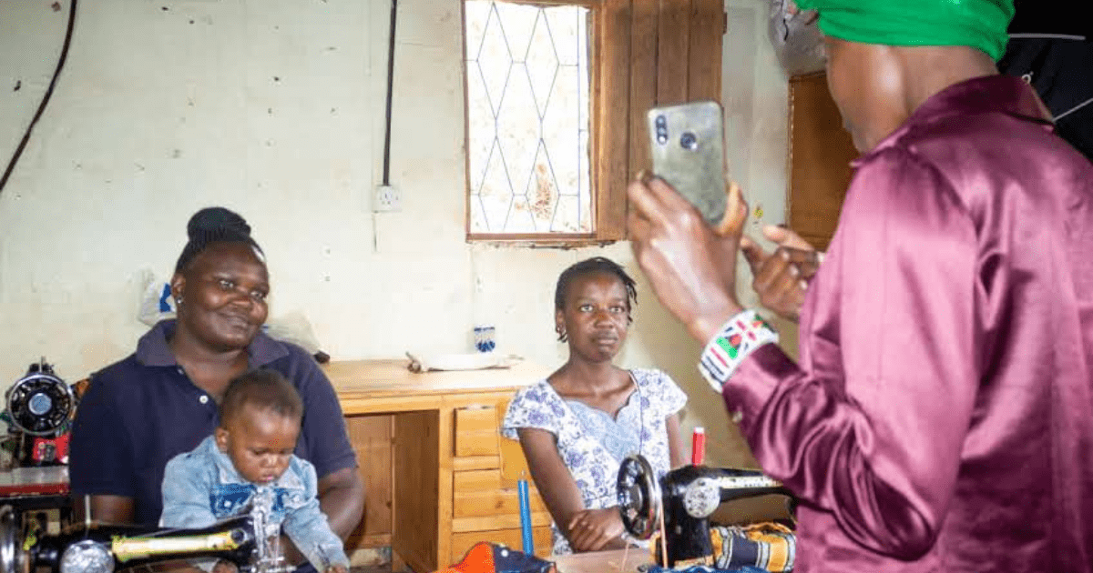 Violet teaching teen mothers how to set up and manage e-commerce platforms via a mobile phone.