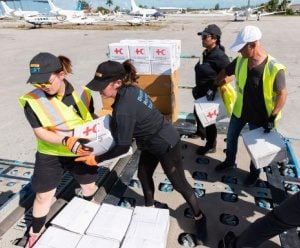 DHL GoHelp volunteers load cargo boxes in a shipment.