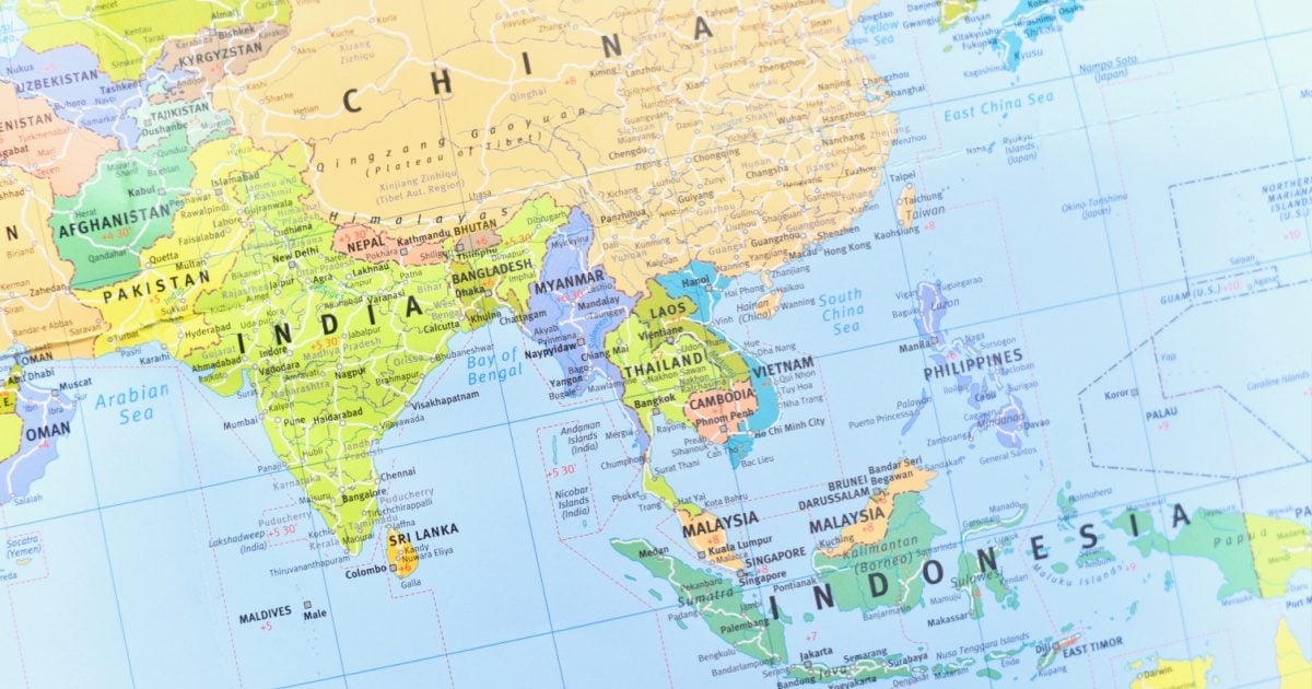 A photo of a world map showing countries in East, South, and South East Asia.