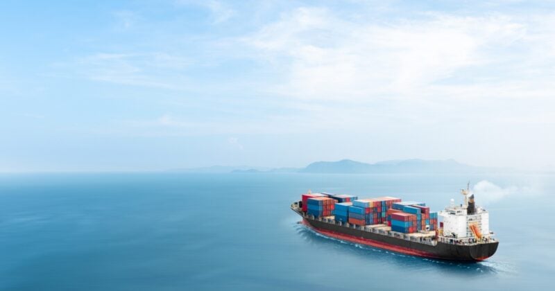 The decrease in ocean vessel speed to reduce fuel costs, emissions, and excess capacity, thereby improving reliability while extending overall transit times.